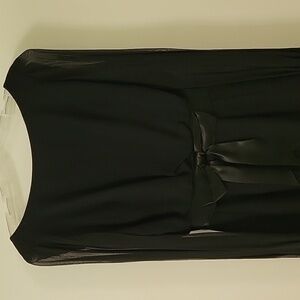 Black crepe/satin dress with long sheer sleeves. Size is 4 to 6.